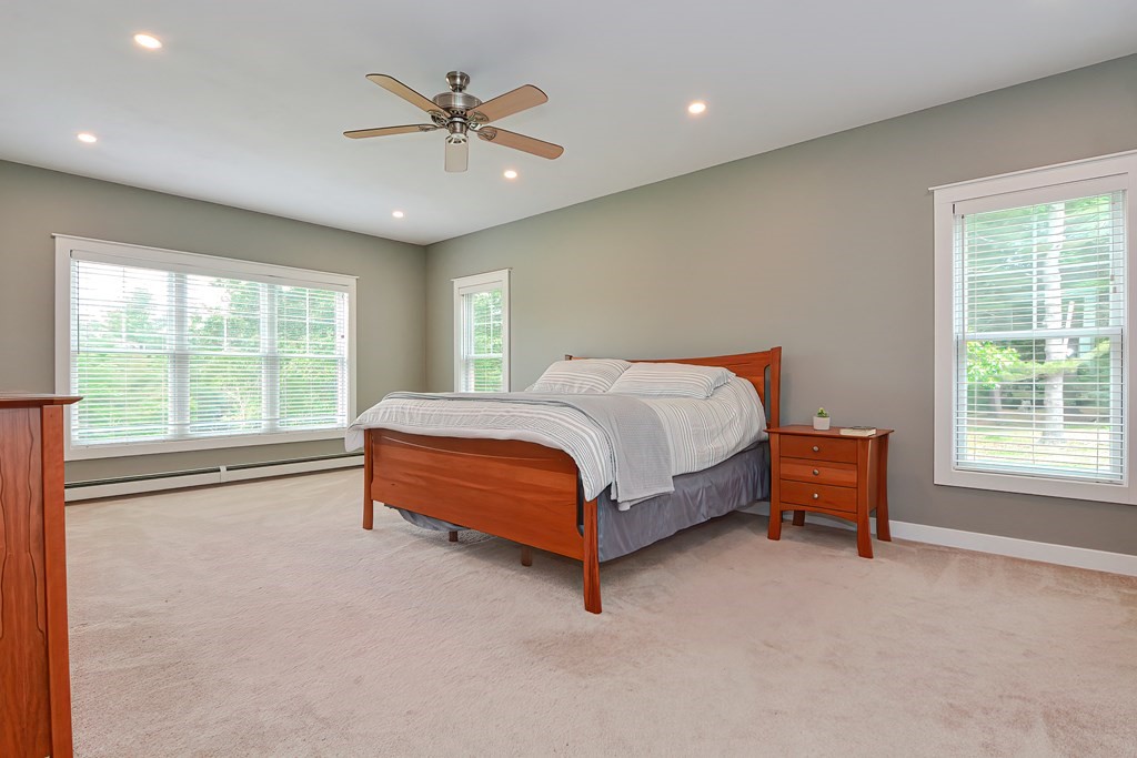 128 Nourse Road Bolton, MA 01740 - Photo 16 of 42 a bedroom with a bed and a couch