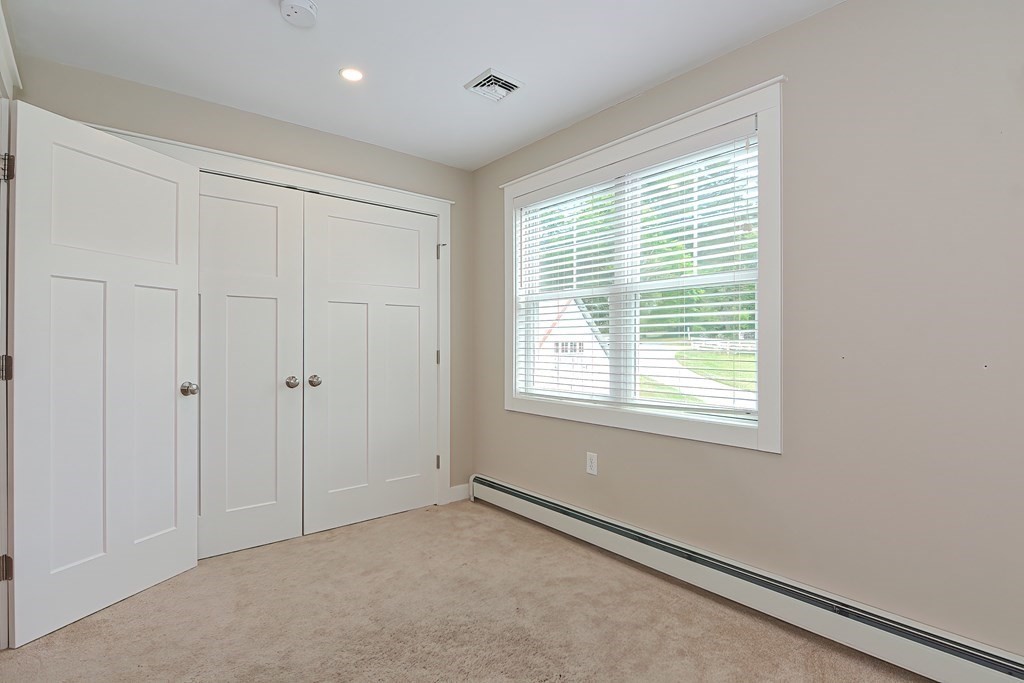 128 Nourse Road Bolton, MA 01740 - Photo 24 of 42 a view of an empty room with a window