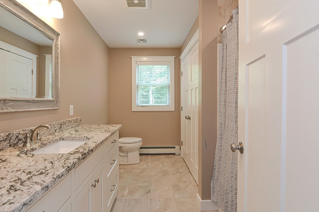 128 Nourse Road Bolton, MA 01740 - Photo 29 of 42 a bathroom with a granite countertop sink toilet and shower