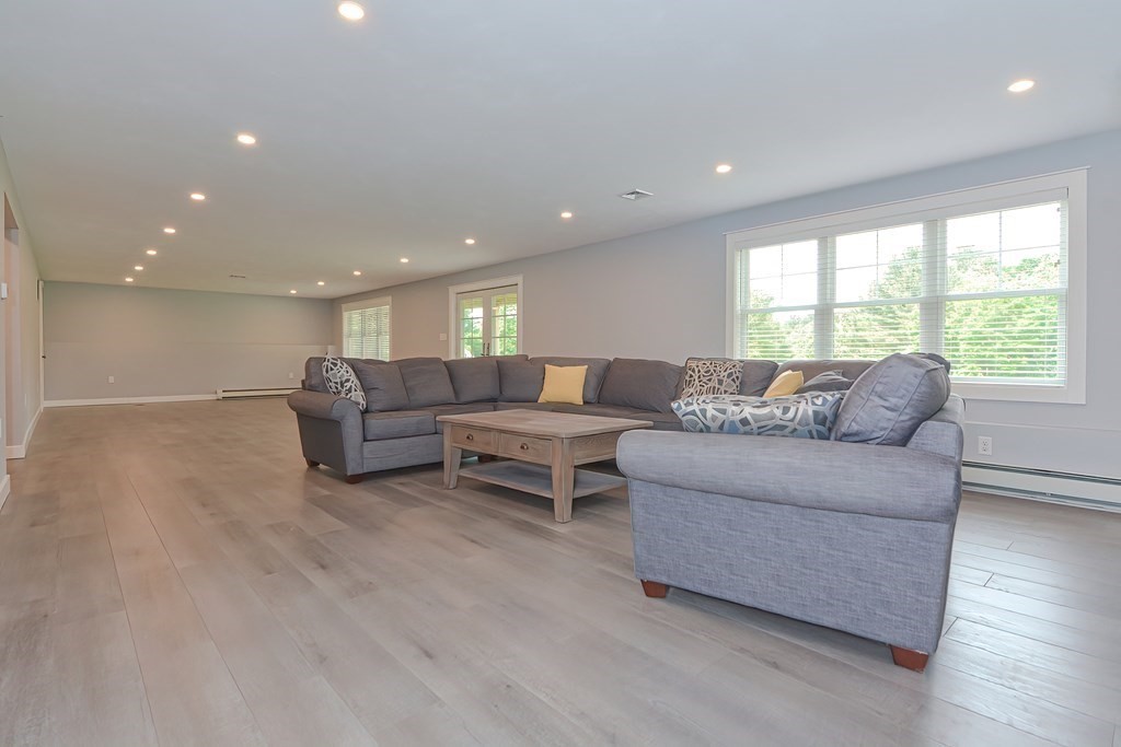 128 Nourse Road Bolton, MA 01740 - Photo 32 of 42 a living room with furniture and a large window