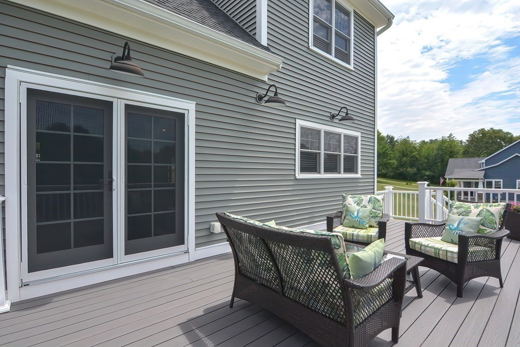 128 Nourse Road Bolton, MA 01740 - Photo 35 of 42 a roof deck with a table and chairs and wooden floor