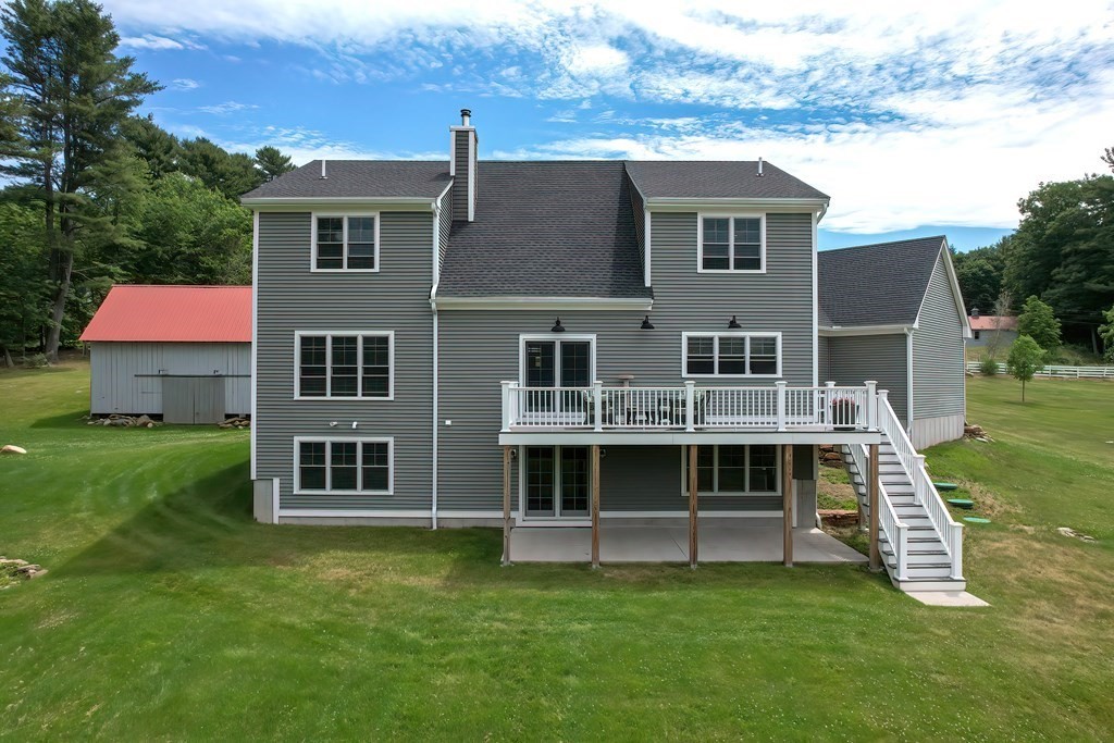 128 Nourse Road Bolton, MA 01740 - Photo 37 of 42 a front view of a house with a yard