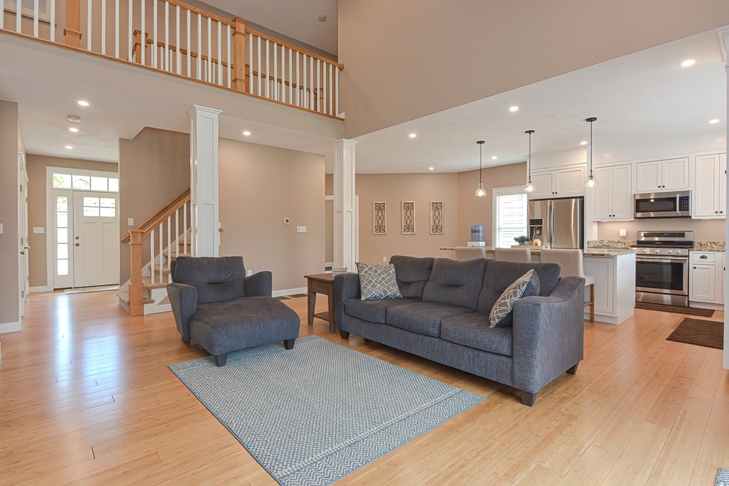 128 Nourse Road Bolton, MA 01740 - Photo 5 of 42 a living room with furniture kitchen and a wooden floor