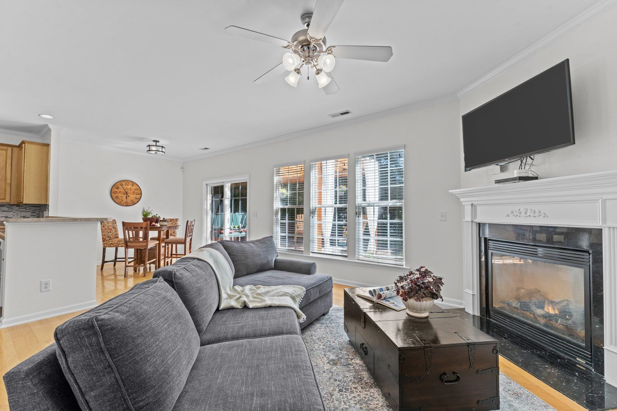 8411 Tie Stone Way Raleigh, NC 27613 - Photo 13 of 38 a living room with furniture a fireplace and a flat screen tv