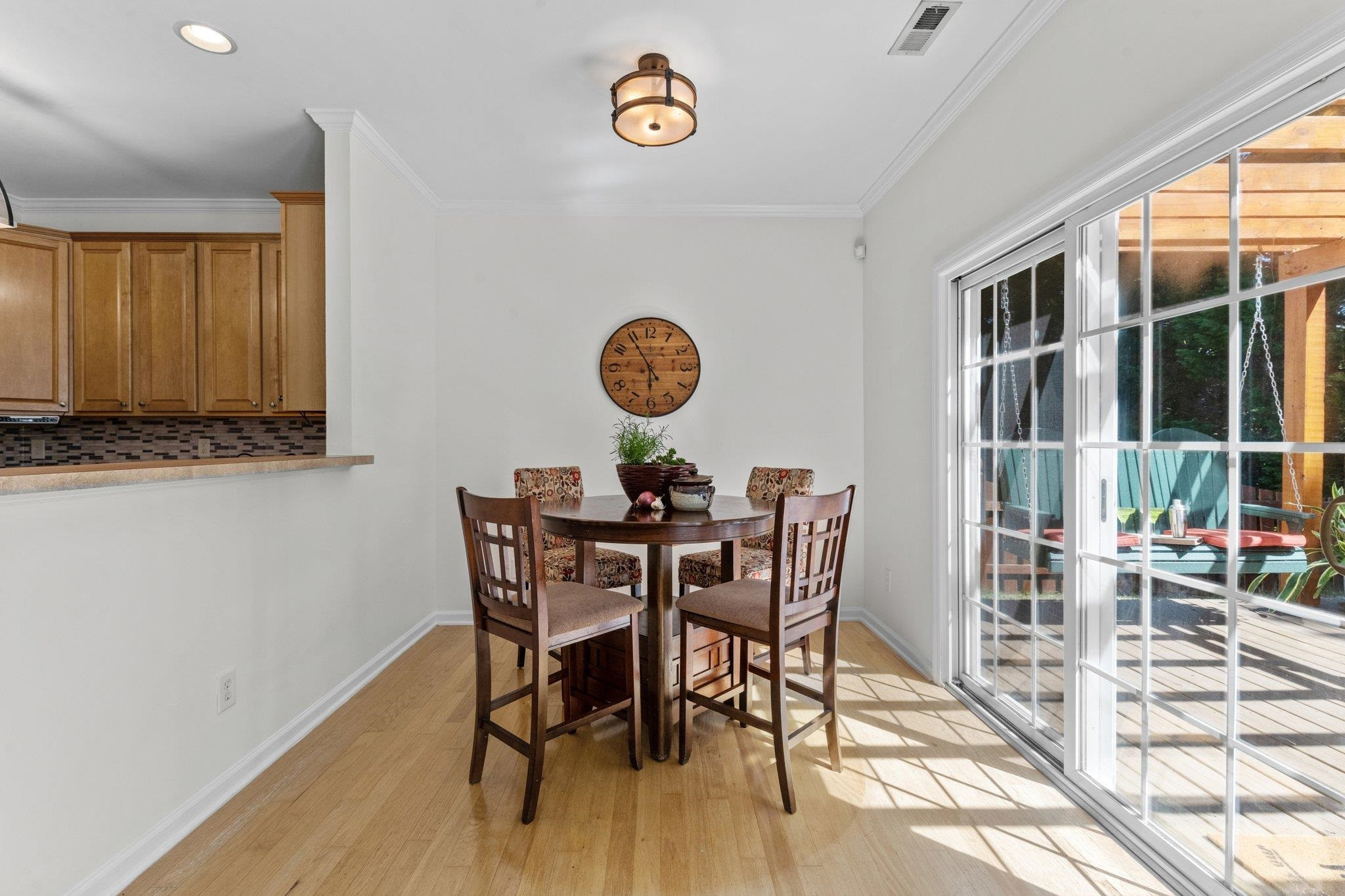 8411 Tie Stone Way Raleigh, NC 27613 - Photo 14 of 38 a view of a dining room with furniture window and wooden floor