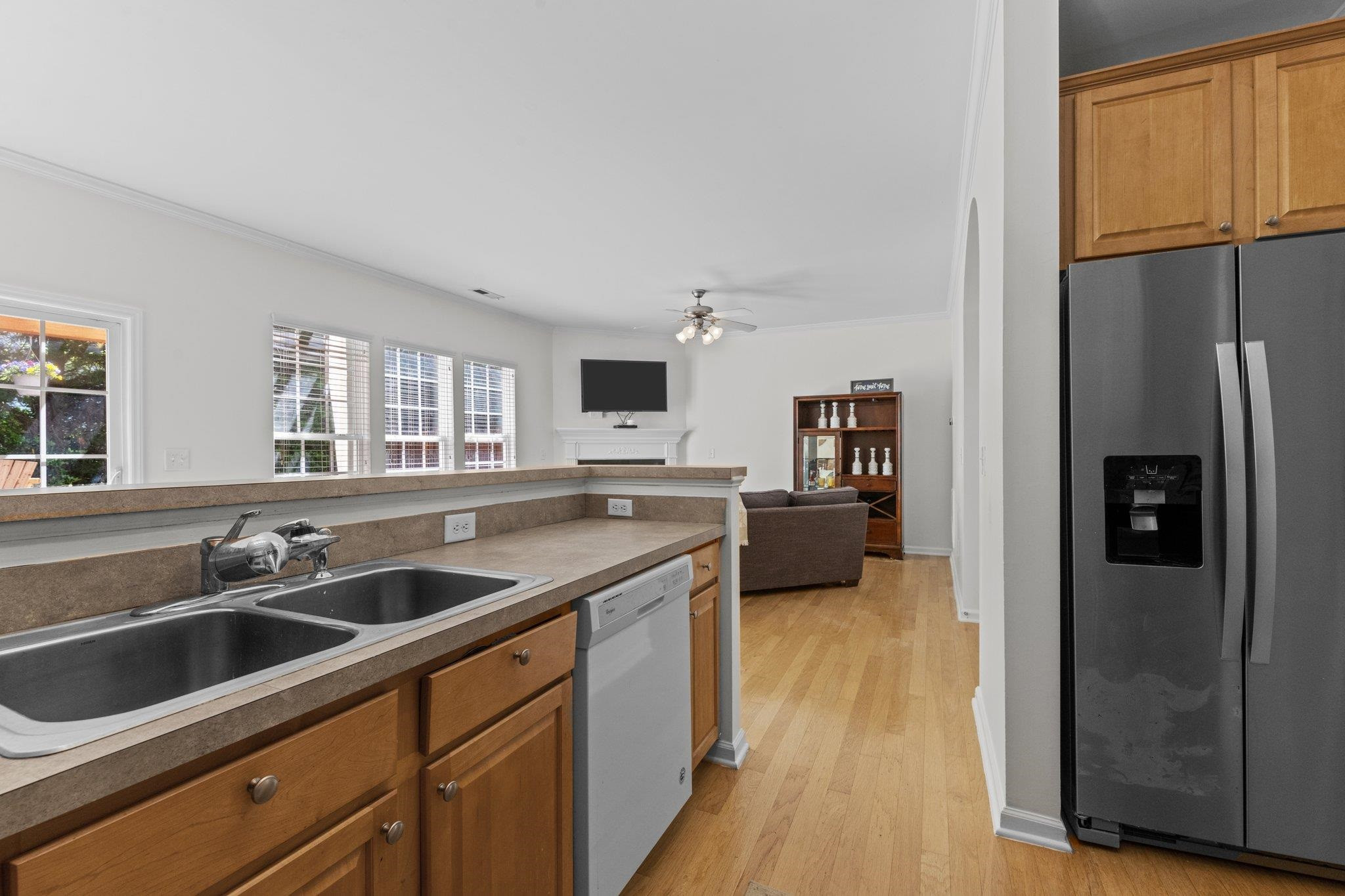 8411 Tie Stone Way Raleigh, NC 27613 - Photo 16 of 38 a kitchen with stainless steel appliances granite countertop a refrigerator a sink and a stove with wooden floors