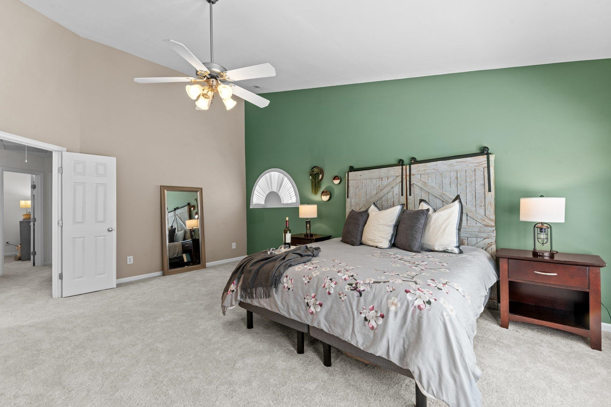 8411 Tie Stone Way Raleigh, NC 27613 - Photo 20 of 38 a bedroom with a bed and a chandelier
