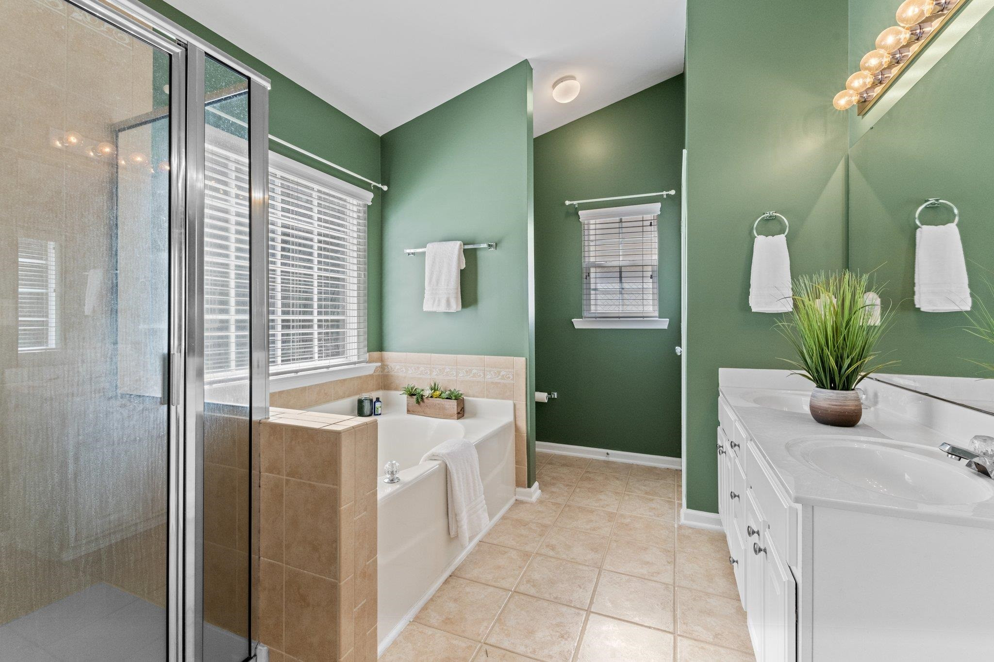 8411 Tie Stone Way Raleigh, NC 27613 - Photo 23 of 38 a bathroom with a tub sink and mirror