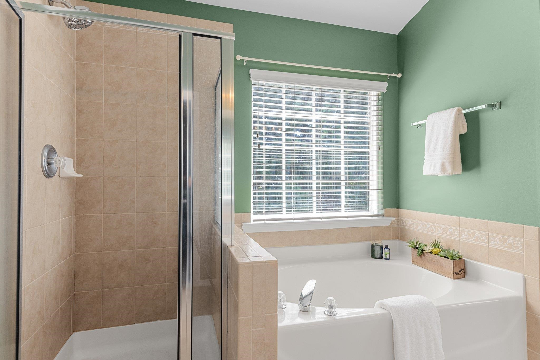 8411 Tie Stone Way Raleigh, NC 27613 - Photo 24 of 38 a bath tub sitting next to a window