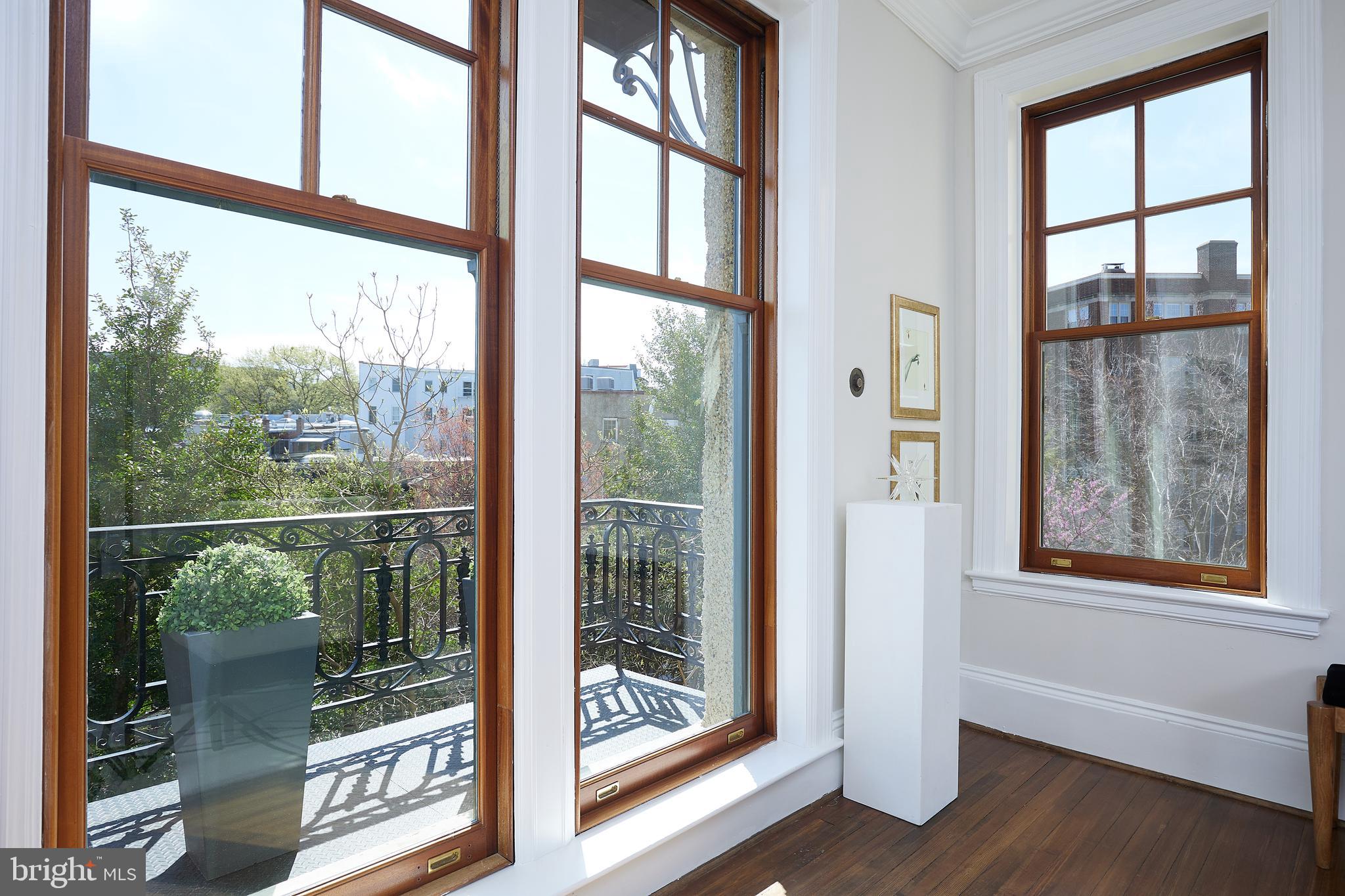 2853 Ontario Road Northwest, Unit 323 Washington, DC 20009 - Photo 12 of 66 a view of a room with a large window and wooden floor