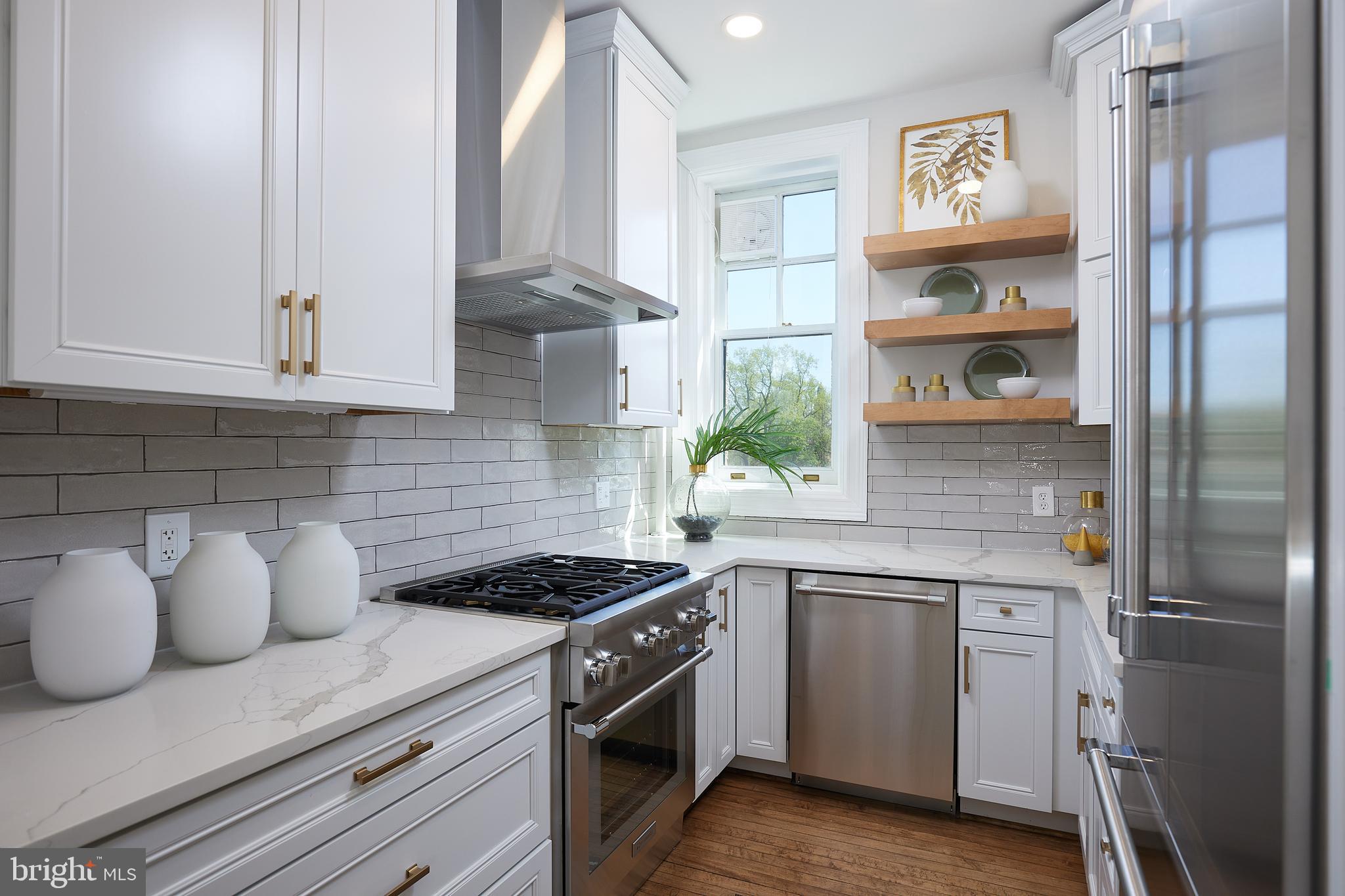 2853 Ontario Road Northwest, Unit 323 Washington, DC 20009 - Photo 26 of 66 a kitchen with stainless steel appliances granite countertop a refrigerator and a stove