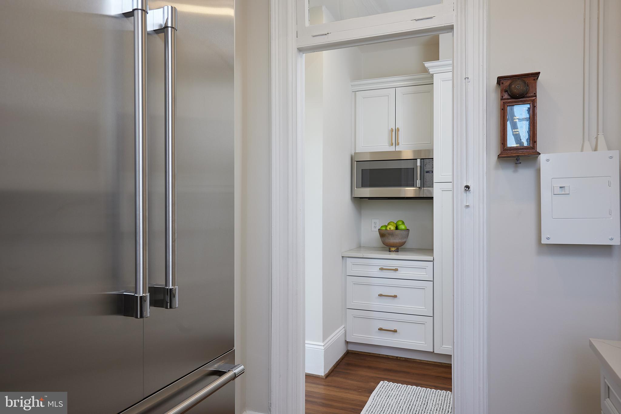 2853 Ontario Road Northwest, Unit 323 Washington, DC 20009 - Photo 29 of 66 a room with closet and wooden floor
