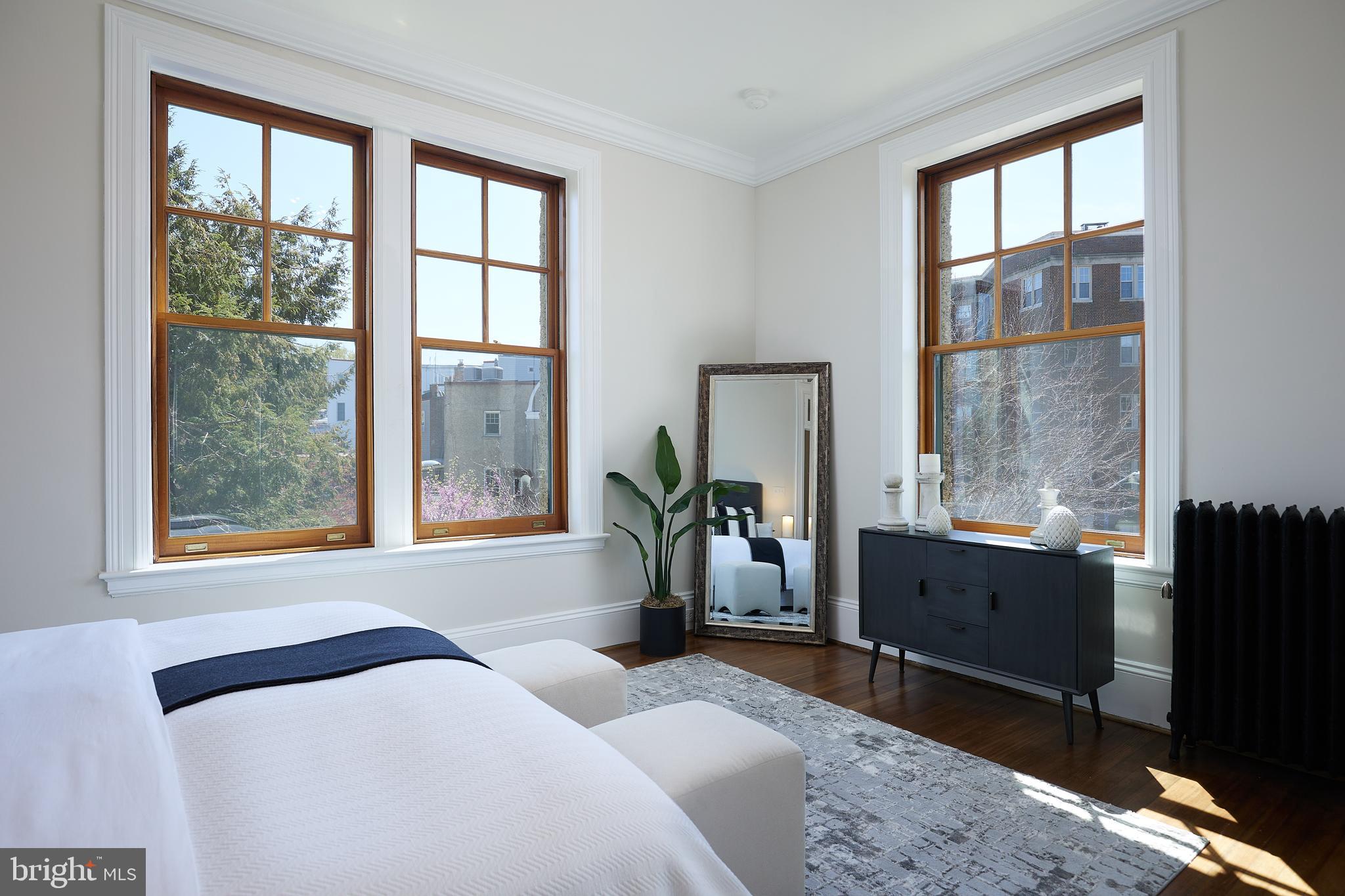 2853 Ontario Road Northwest, Unit 323 Washington, DC 20009 - Photo 31 of 66 a bedroom with a bed and large windows