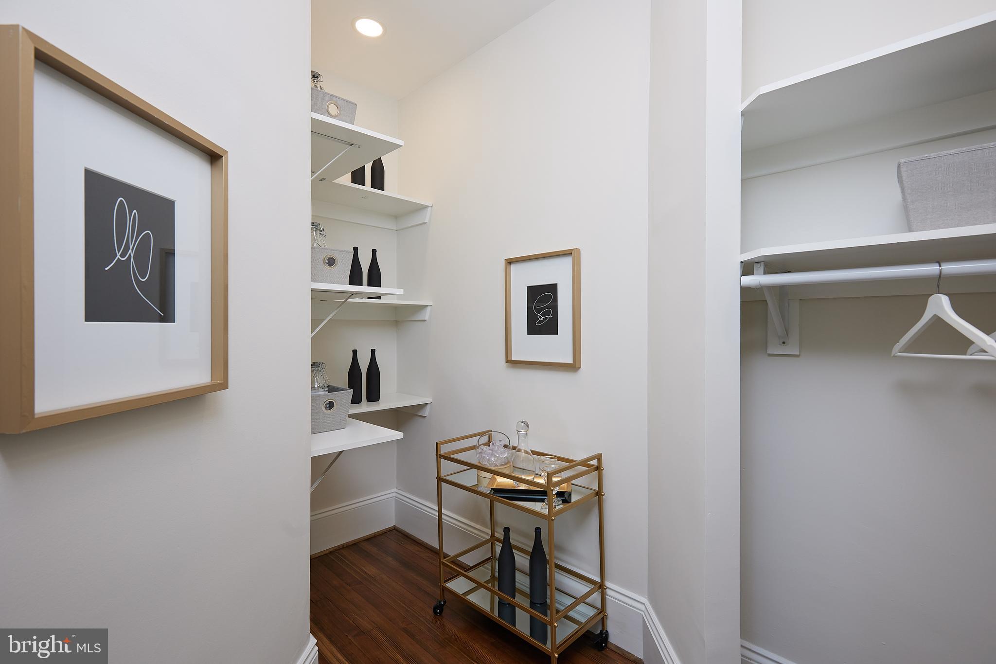 2853 Ontario Road Northwest, Unit 323 Washington, DC 20009 - Photo 32 of 66 a room with cabinets and wooden floor