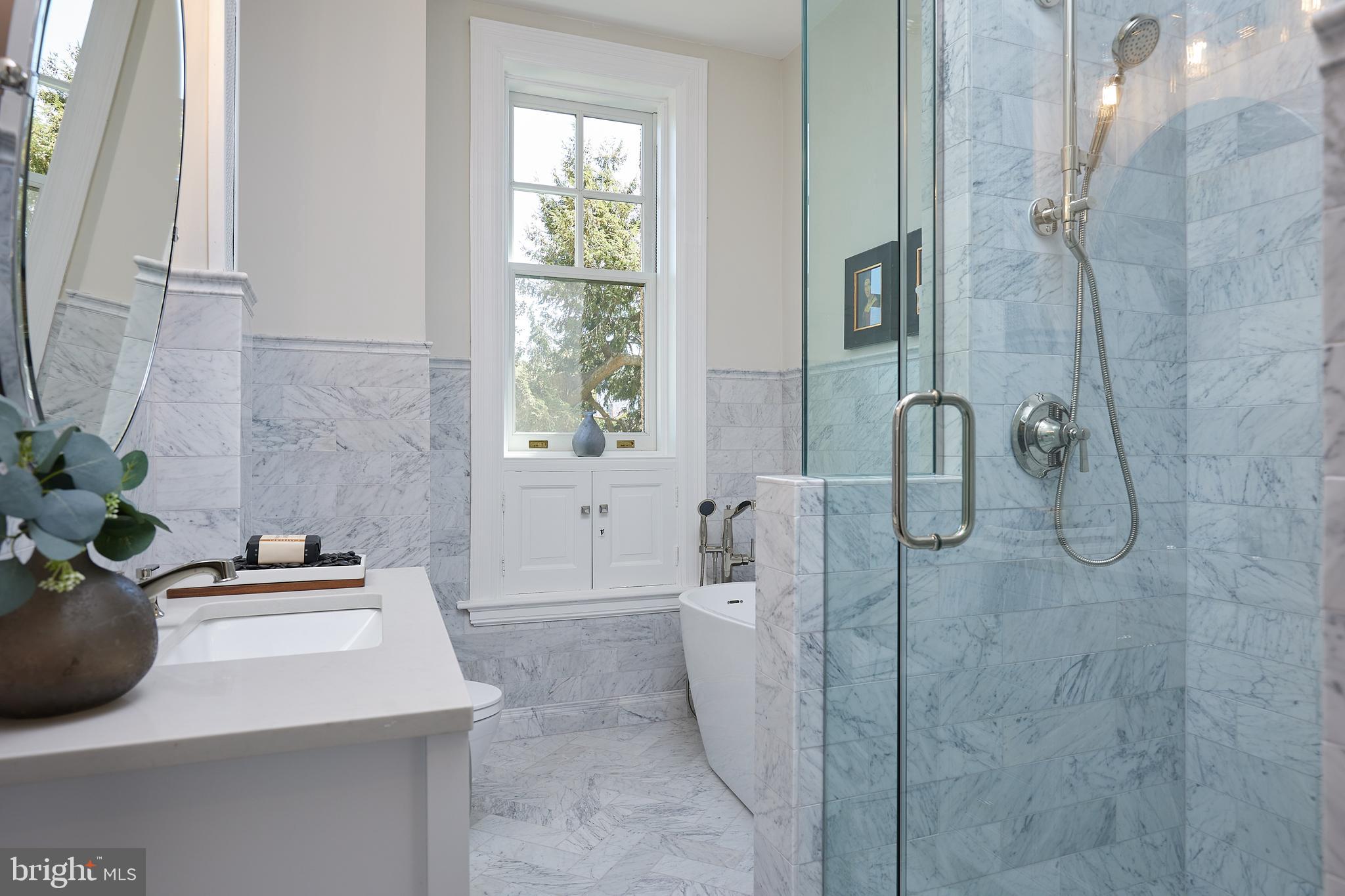 2853 Ontario Road Northwest, Unit 323 Washington, DC 20009 - Photo 43 of 66 a bathroom with a sink and mirror with bathtub