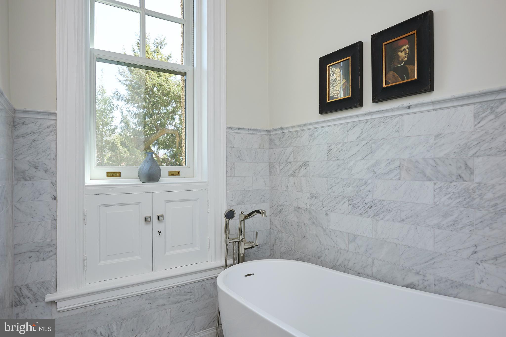2853 Ontario Road Northwest, Unit 323 Washington, DC 20009 - Photo 44 of 66 a bathroom with a bathtub and a window