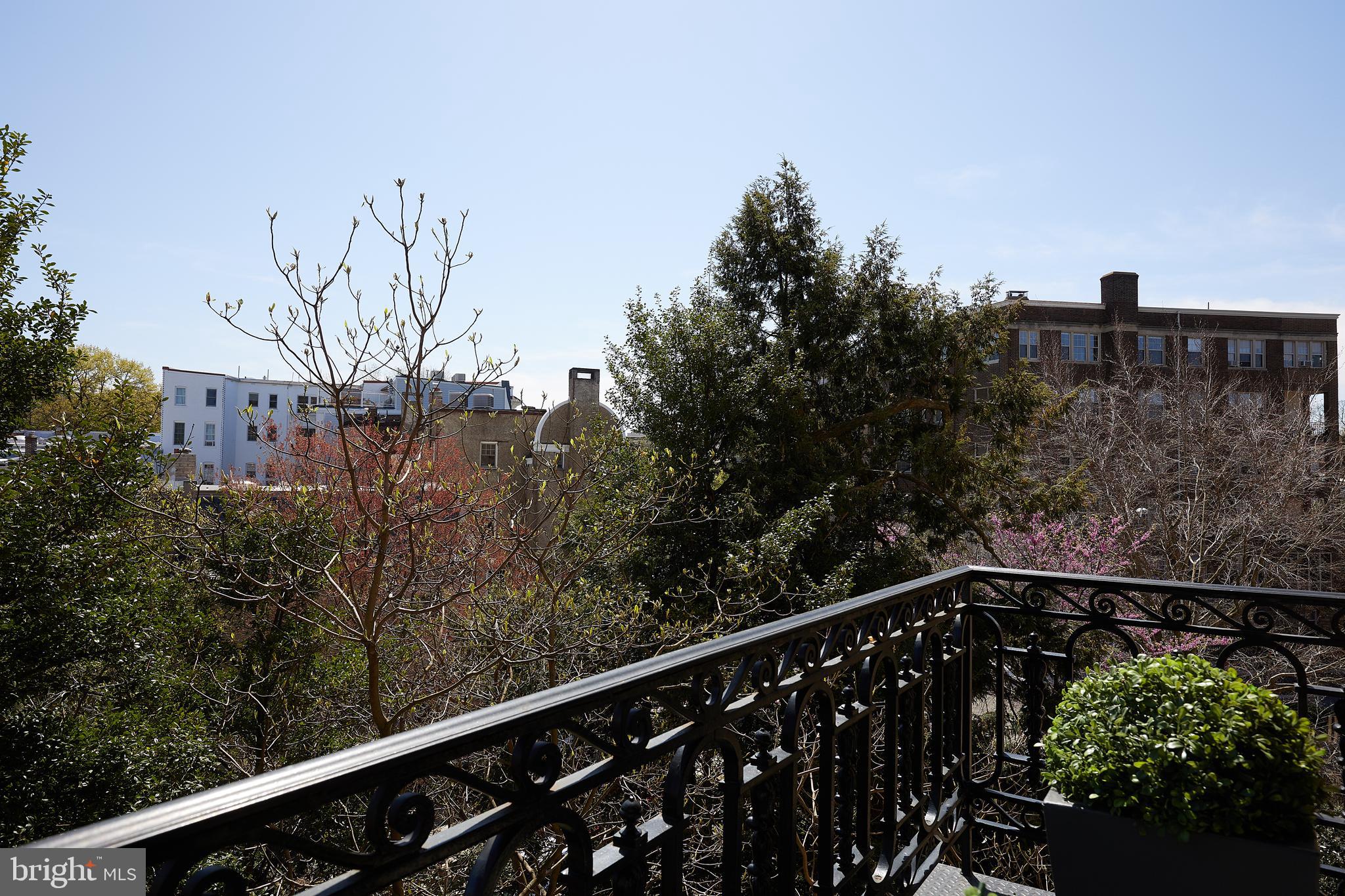 2853 Ontario Road Northwest, Unit 323 Washington, DC 20009 - Photo 48 of 66 a view of a balcony with wooden fence and floor