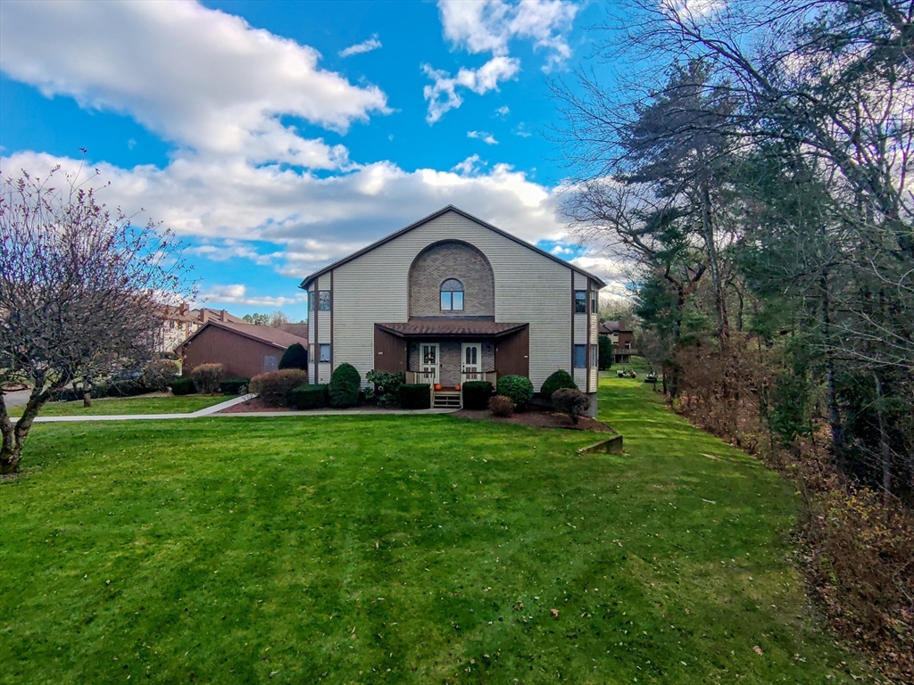 2 Pine Grove Drive, Unit 2 South Hadley, MA 01075 - Photo 2 of 34 a view of a wooden house with a big yard and large trees
