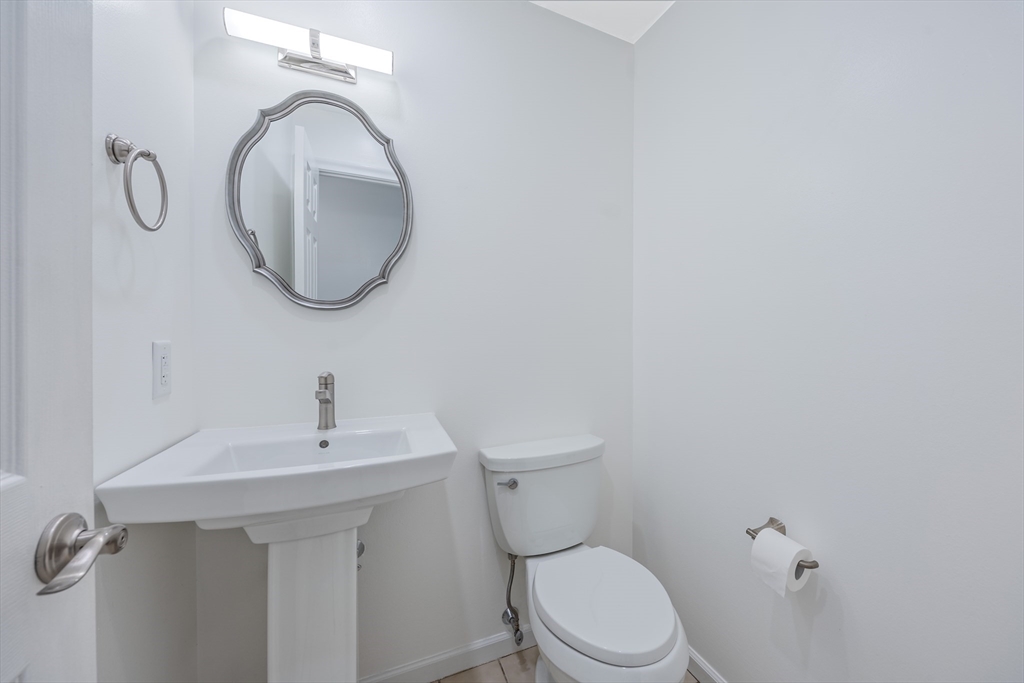 2 Pine Grove Drive, Unit 2 South Hadley, MA 01075 - Photo 24 of 34 a bathroom with a sink a toilet and a mirror