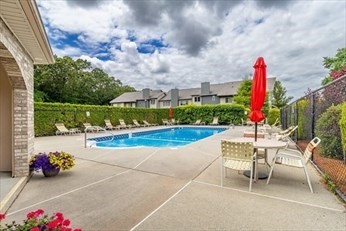 2 Pine Grove Drive, Unit 2 South Hadley, MA 01075 - Photo 34 of 34 a view of a patio with a table and chairs and potted plants