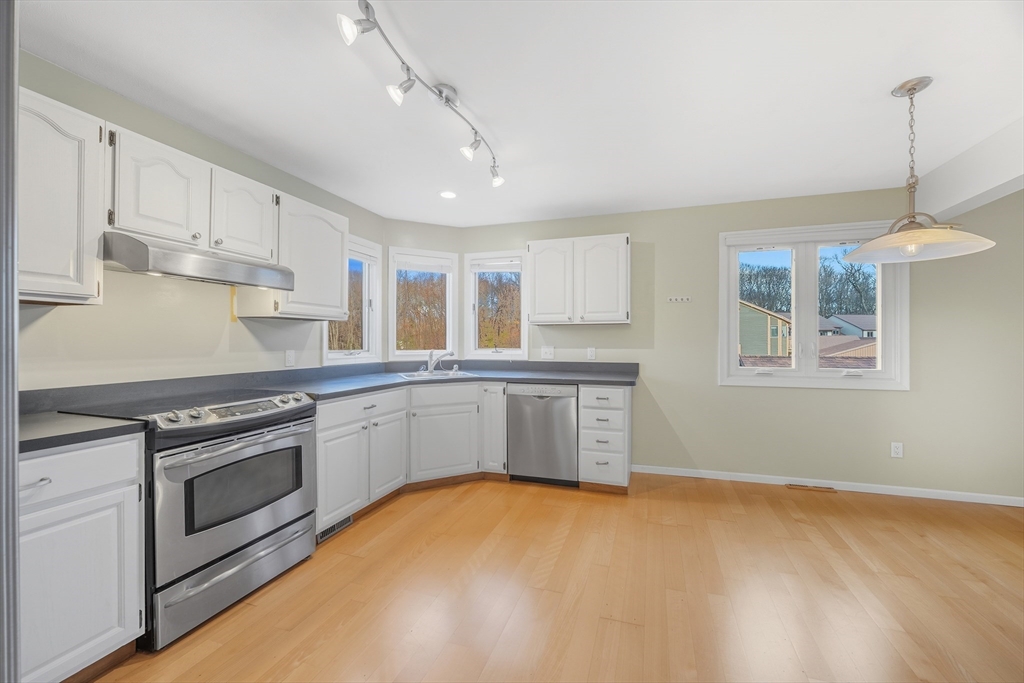 2 Pine Grove Drive, Unit 2 South Hadley, MA 01075 - Photo 7 of 34 a kitchen with stainless steel appliances granite countertop a stove sink and cabinets