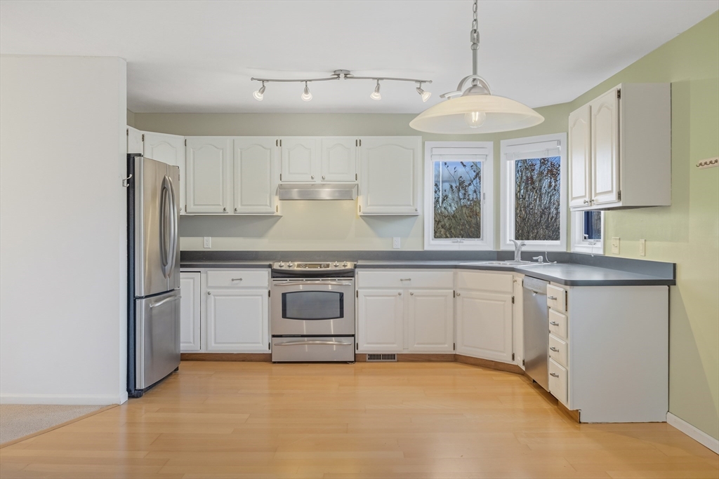 2 Pine Grove Drive, Unit 2 South Hadley, MA 01075 - Photo 8 of 34 a kitchen with kitchen island granite countertop white cabinets stainless steel appliances and a counter space