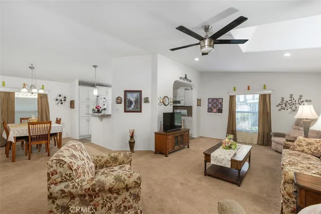 a living room with furniture and a ceiling fan