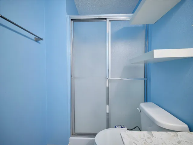 a bathroom with a sink toilet and mirror