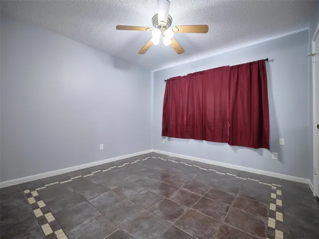 a view of room with a window and a door