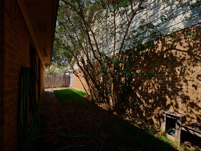 a view of a patio with table and chairs with wooden fence