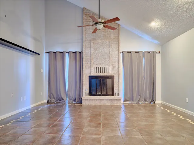 a view of a livingroom with a fireplace and window