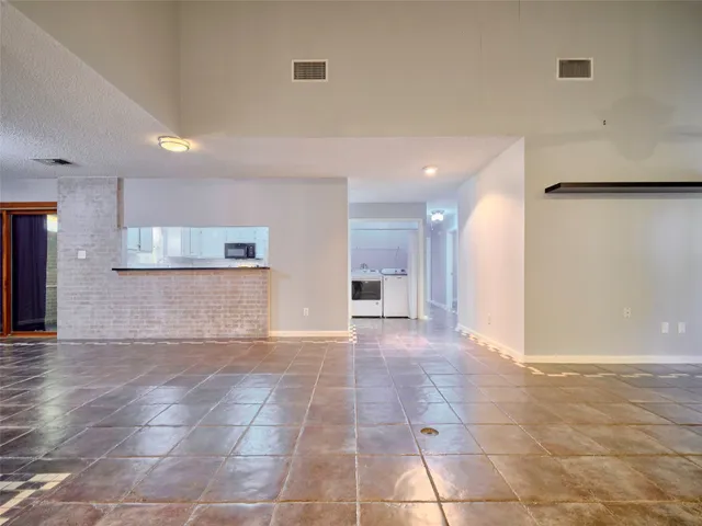 a view of a hallway with an empty room and fire place