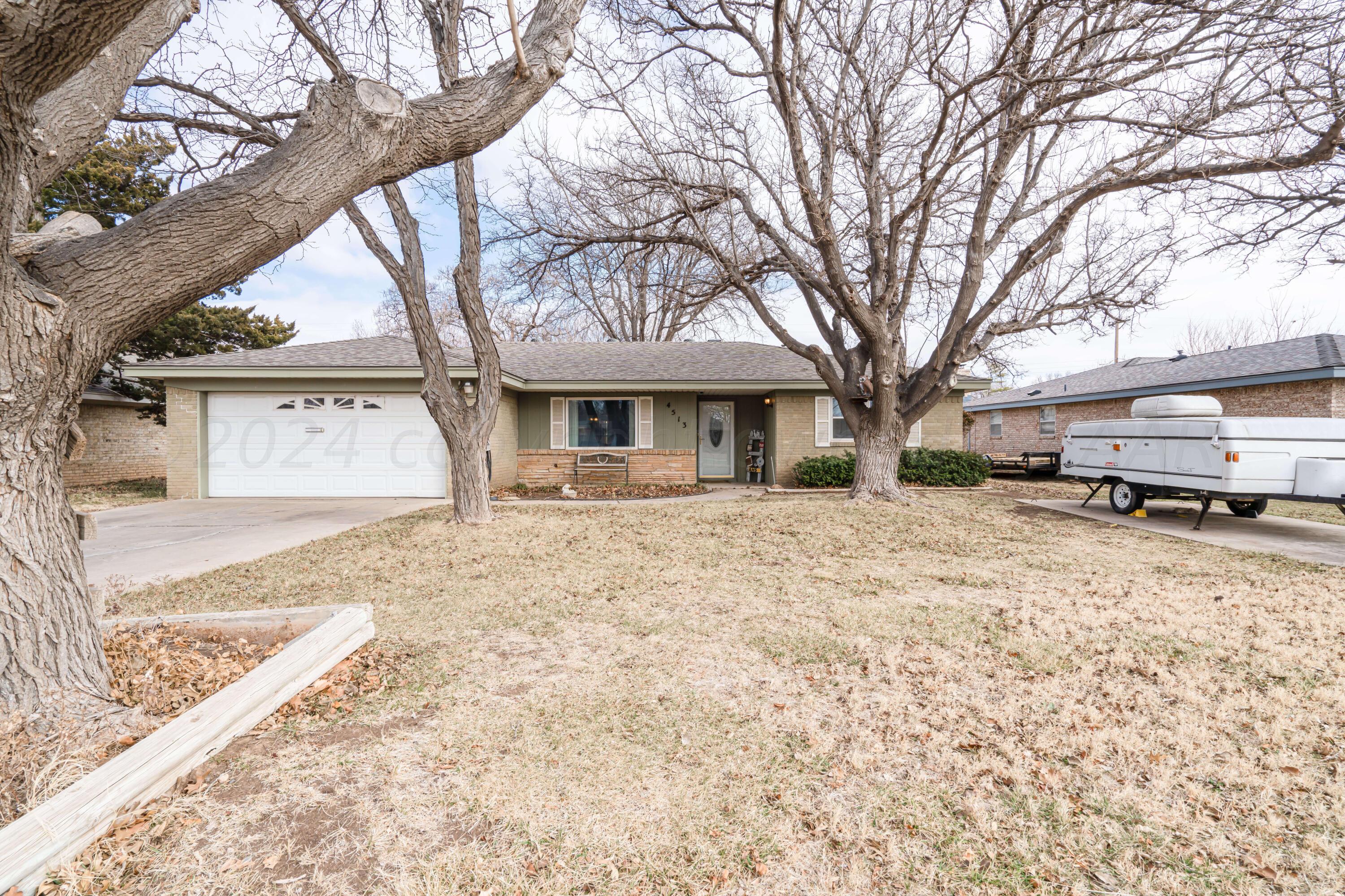 a front view of a house with a yard covered with snow in front of house
