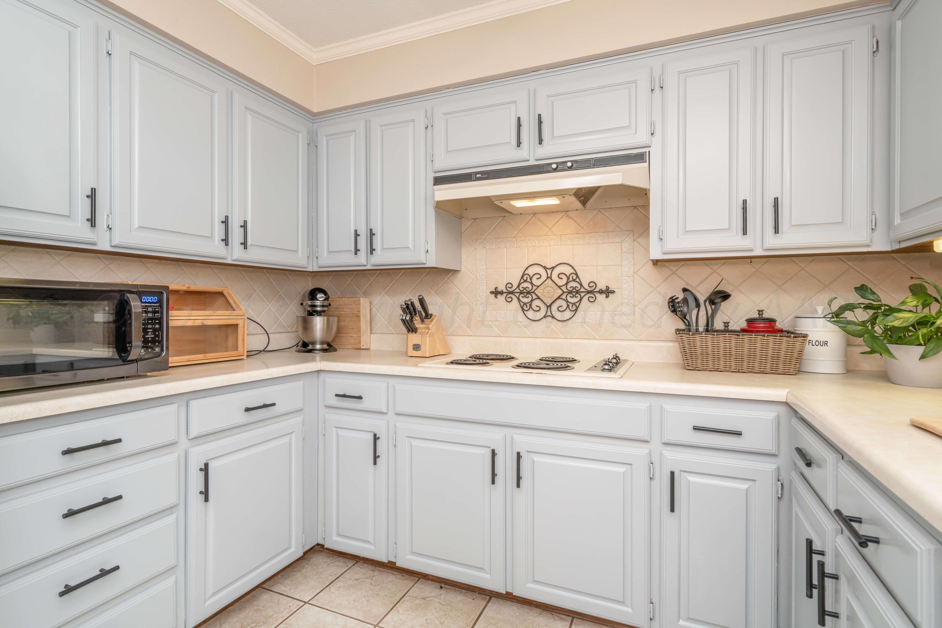 4513 Mesa Circle Amarillo, TX 79109 - Photo 12 of 18 a kitchen with white cabinets and white appliances