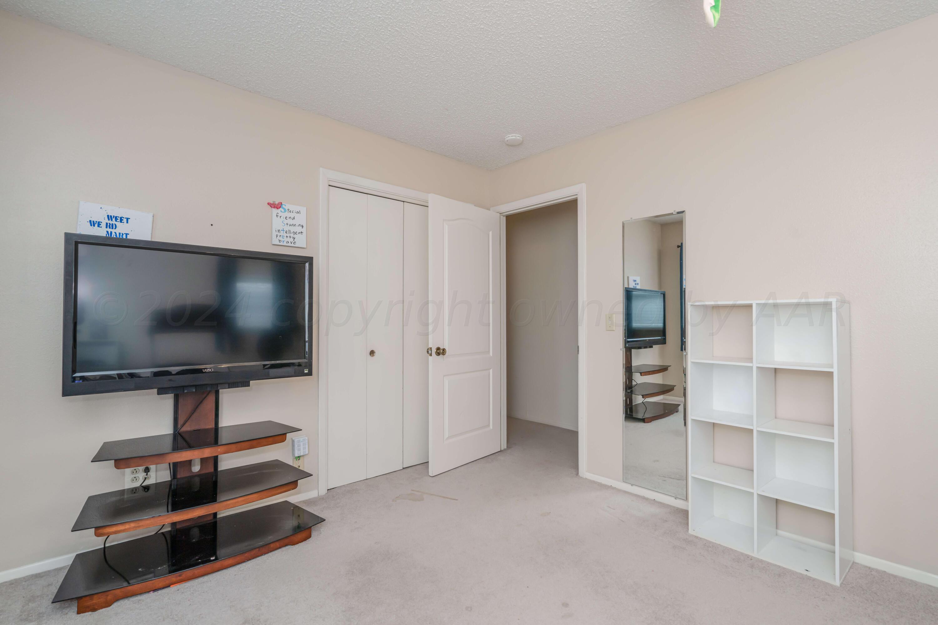 4513 Mesa Circle Amarillo, TX 79109 - Photo 14 of 18 a living room with furniture and a flat screen tv