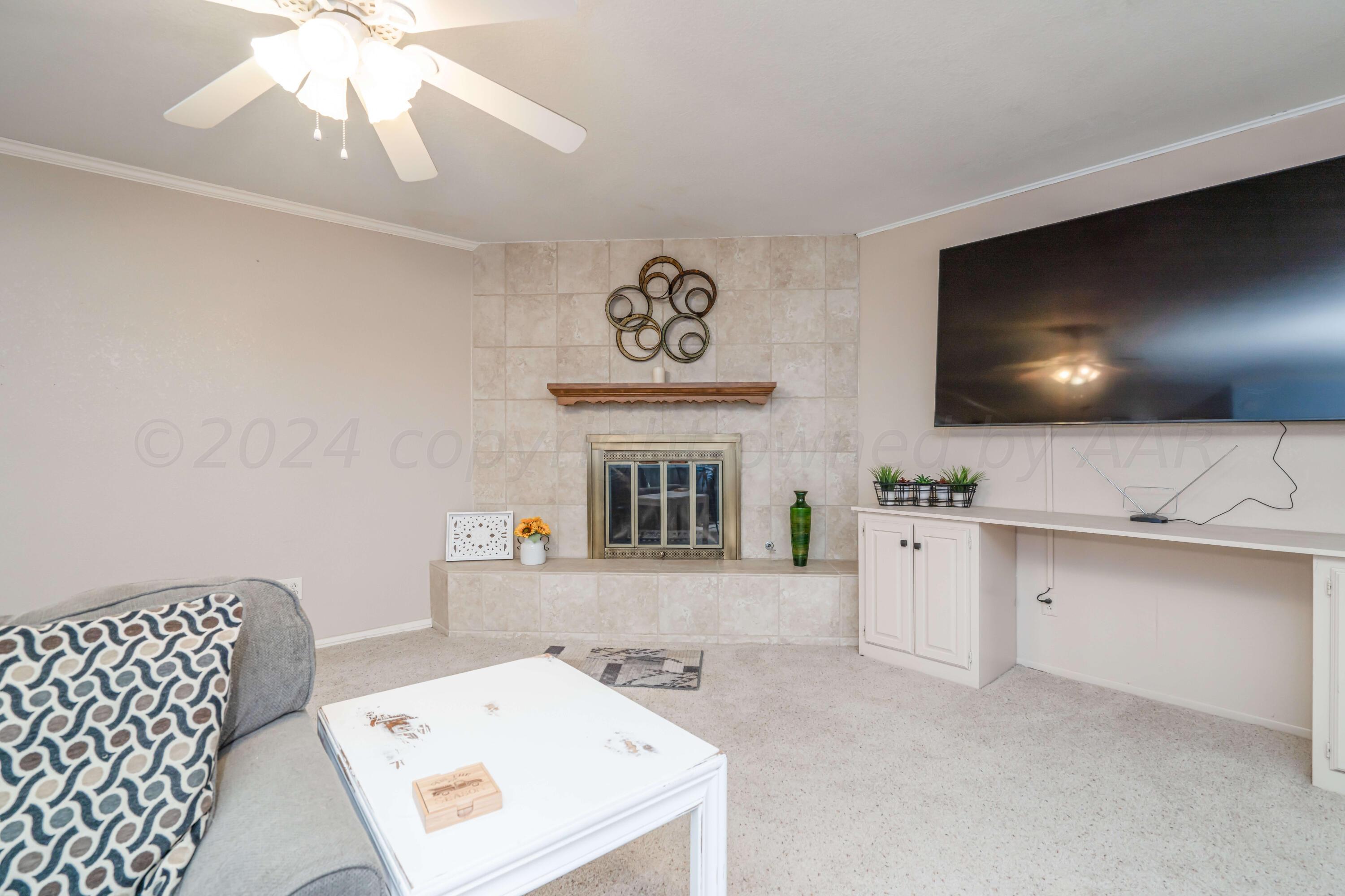 4513 Mesa Circle Amarillo, TX 79109 - Photo 9 of 18 a living room with furniture and a flat screen tv