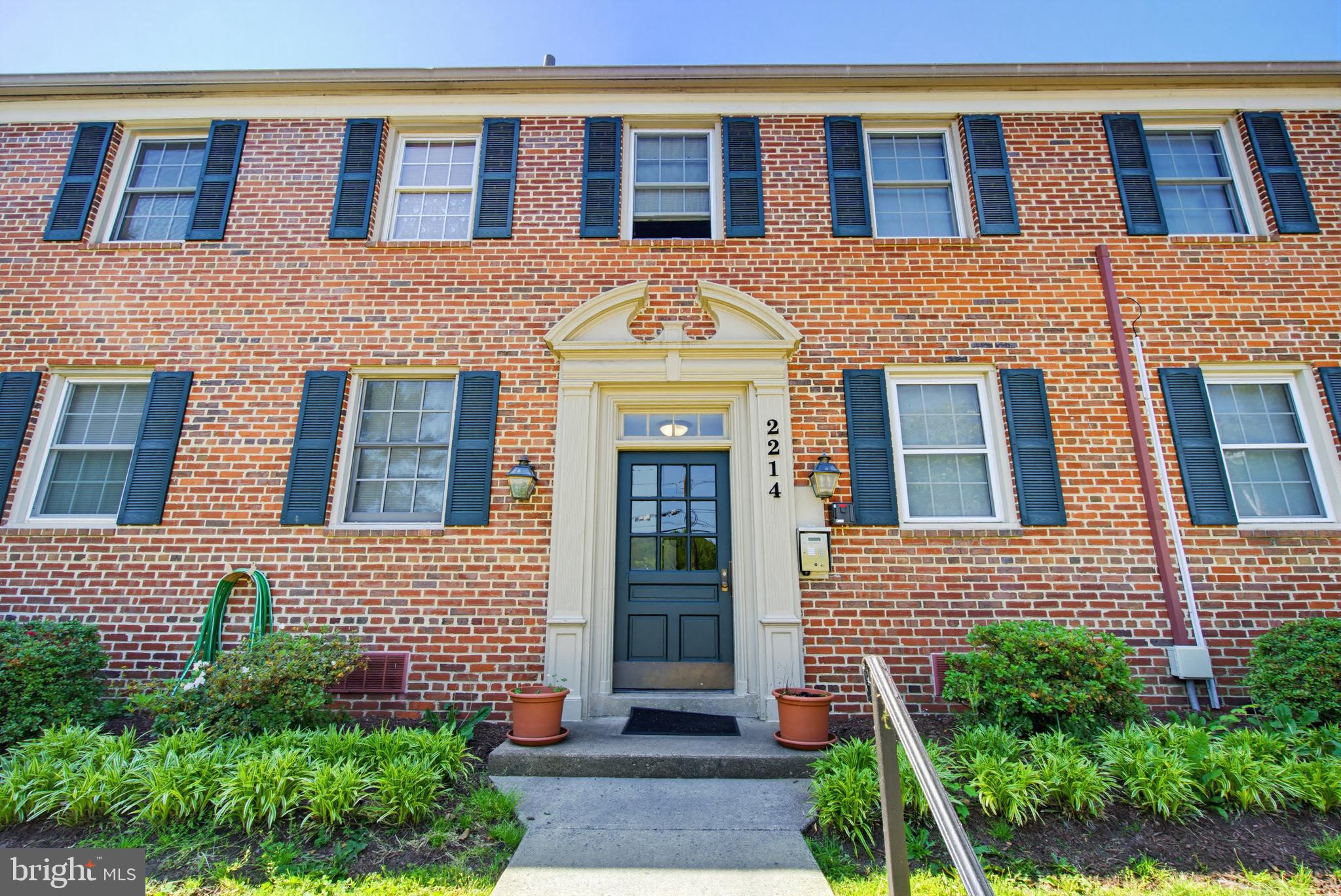 2214 Colston Drive, Unit 201 Silver Spring, MD 20910 - Photo 32 of 43 a view of a brick building next to a yard