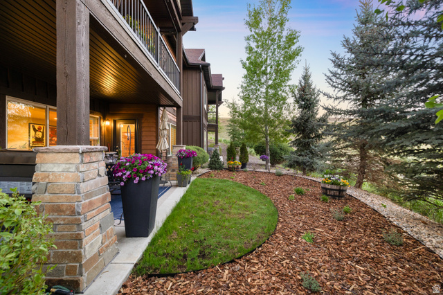 1737 East Viewside Circle Hideout, UT 84036 - Photo 26 of 35 Covered outdoor patio with stone-wrapped columns and a wood-paneled ceiling