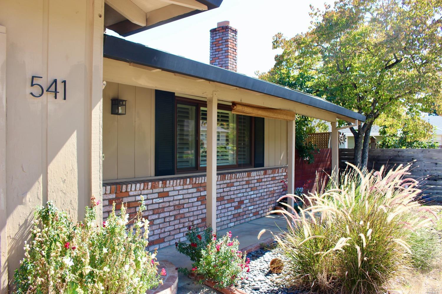 a front view of a house with a garden