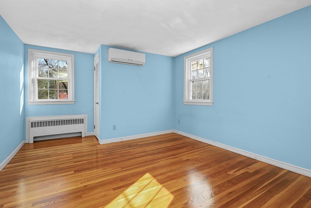 8 Autumn Lane Walpole, MA 02081 - Photo 14 of 28 a view of an empty room with wooden floor and a window