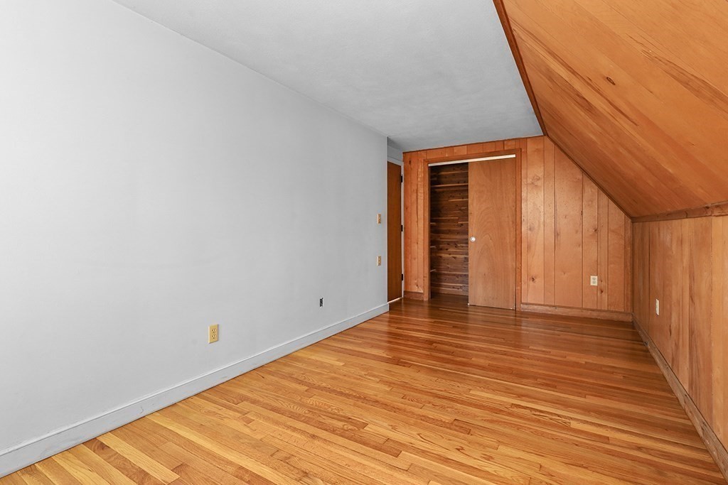 8 Autumn Lane Walpole, MA 02081 - Photo 17 of 28 a view of an empty room with wooden floor and a window