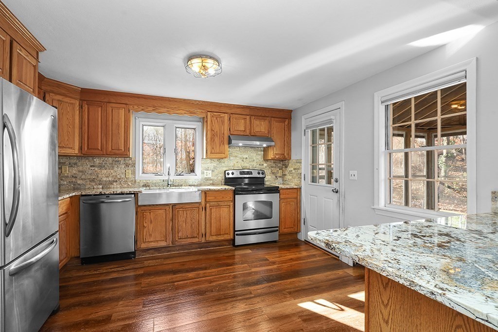 8 Autumn Lane Walpole, MA 02081 - Photo 4 of 28 a kitchen with granite countertop wooden floors and stainless steel appliances