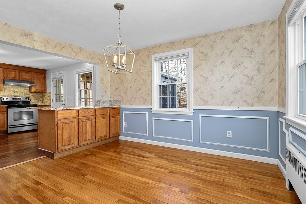 8 Autumn Lane Walpole, MA 02081 - Photo 7 of 28 a view of a kitchen with stainless steel appliances granite countertop a stove a sink dishwasher a microwave oven with cabinets and wooden floor