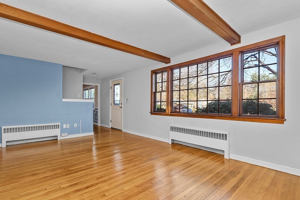 8 Autumn Lane Walpole, MA 02081 - Photo 10 of 28 a view of an empty room with wooden floor and a window