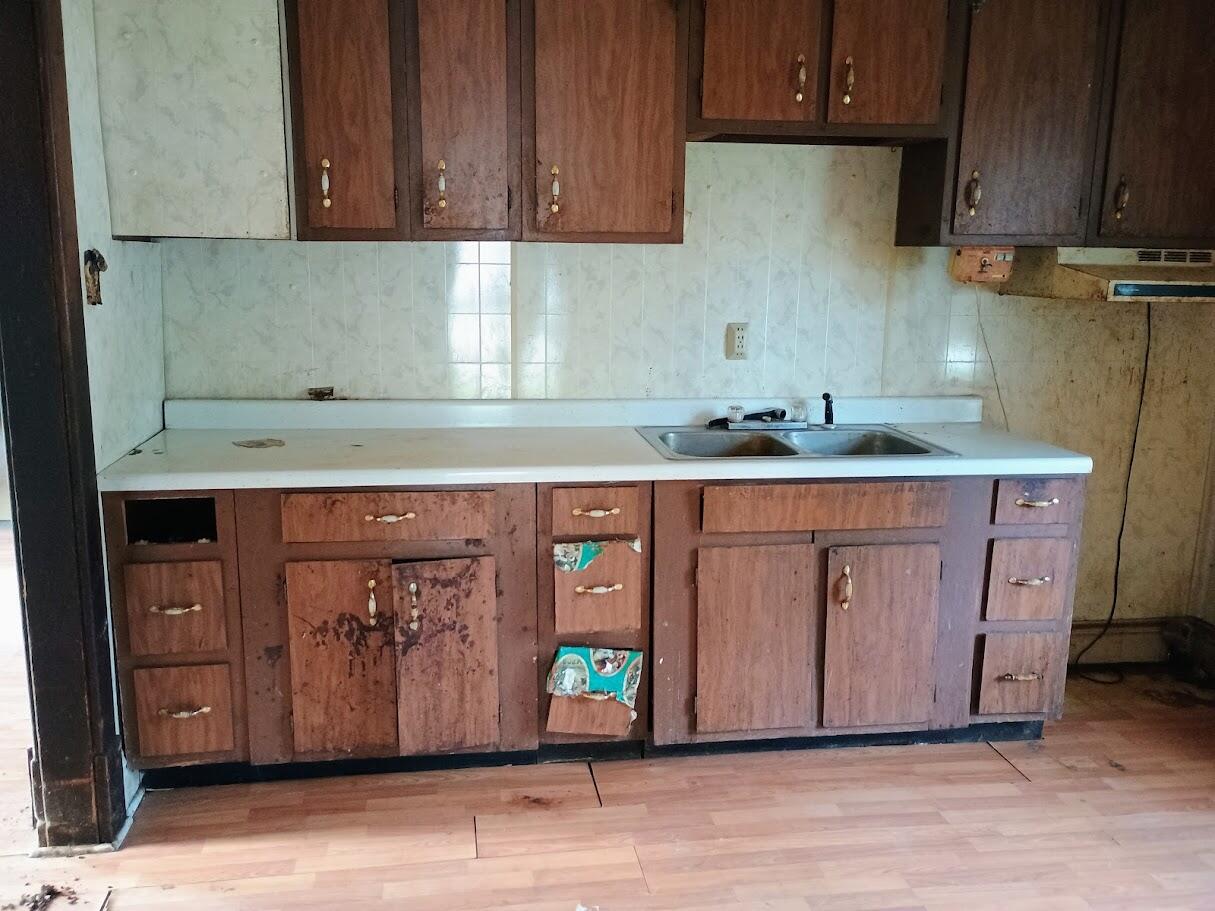 419 Main Street North Judson, IN 46366 - Photo 6 of 9 a kitchen with a sink cabinets and wooden floor