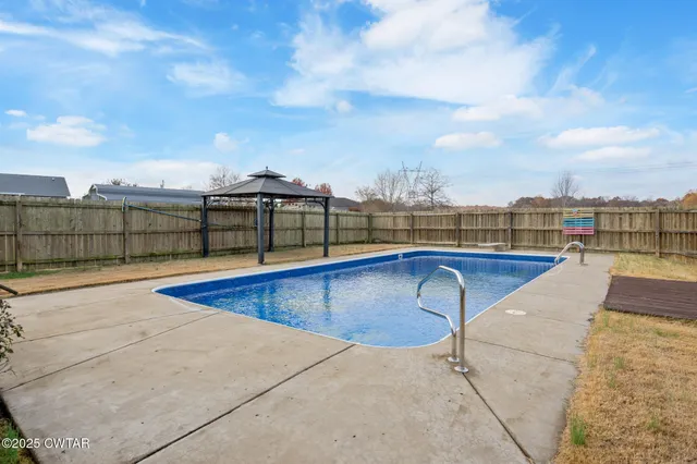 a view of swimming pool with a lounge chair
