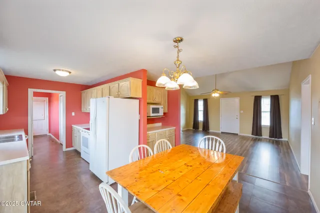 a view of a livingroom with a furniture wooden floor and chandelier