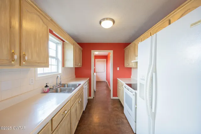 a kitchen with a sink and a large window