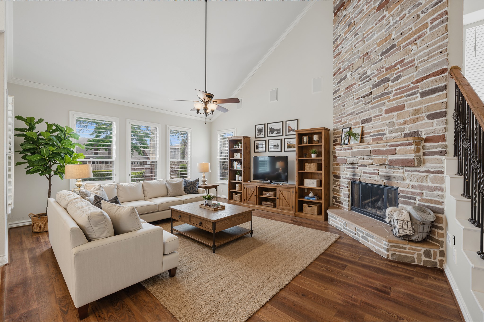 315 Arbor Ridge Lane Conroe, TX 77384 - Photo 6 of 48 Soaring ceilings, beautiful hardwood floors, stone fireplace, plantation shutters, open to the kitchen and breakfast areas - what more could you ask for in a family room! Virtually Staged.
