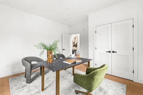 a view of a hallway with windows and stairs